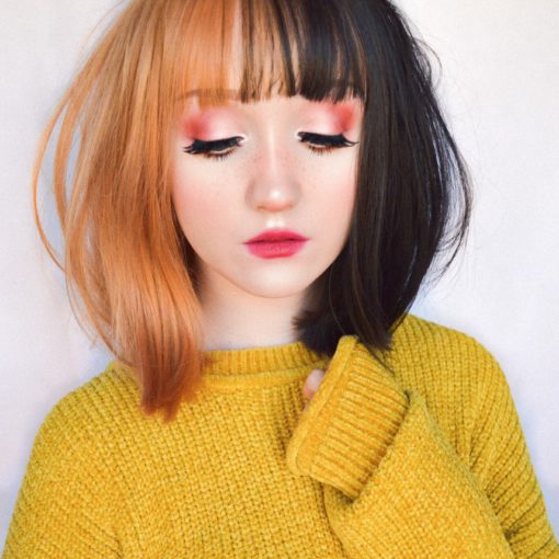 Bumble takes on the split colouring technique that's soft and cute. Split down the middle of the centre parting. One half is a light amber and the other side is a cool black. With a light fringe.