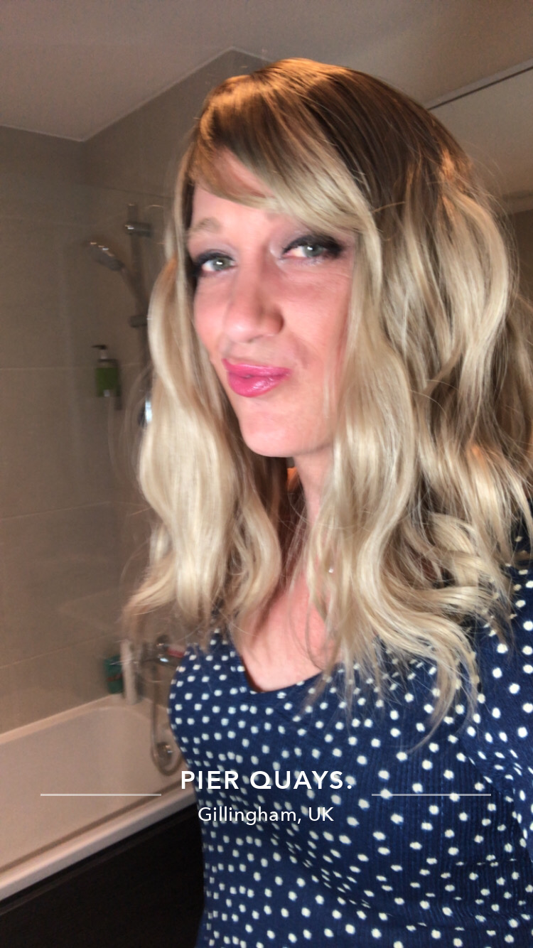 Eleri - Lush Wigs UK This long bob with dark brown shadow roots blend into a warm blonde hue. Styled in a loose wave with a sleek blunt fringe.