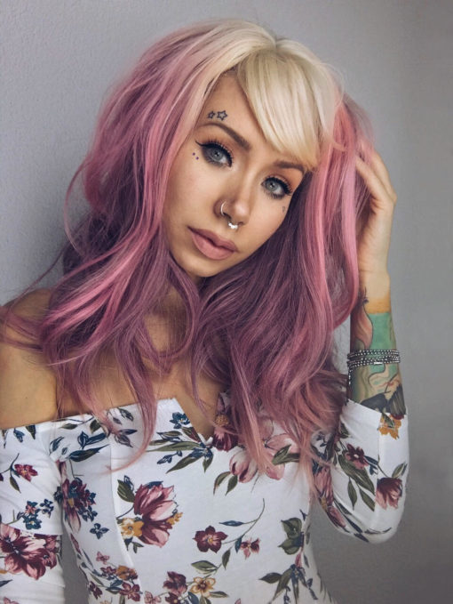 Blonde and pink long straight wig with bangs. Be the belle of the ball in dreamy Lullaby! With its bleach blonde overgrown roots. The angles of its very loose waves, reflects different tones of deep rose pink. A light airy blonde fringe with a touch of muted pink that skims the brow-bones.
