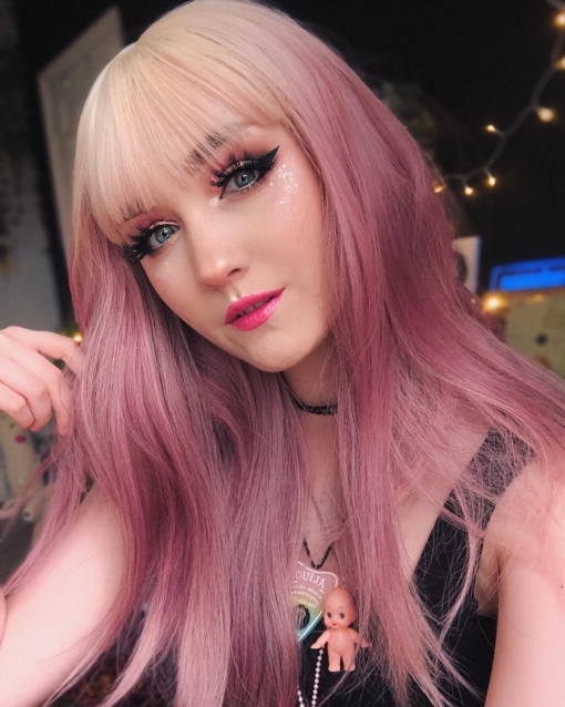 Be the belle of the ball in dreamy Lullaby! With its bleach blonde overgrown roots. The angles of its very loose waves, reflects different tones of deep rose pink. A light airy blonde fringe with a touch of muted pink that skims the brow-bones.