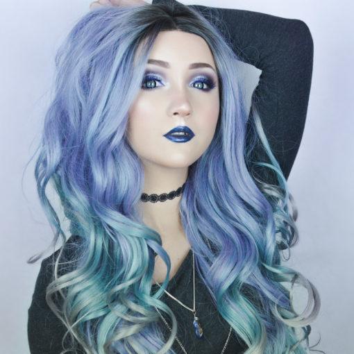 Multi coloured long curly lace front wig. A concoction of galaxies of colours make up Jupiter. With a natural twist of black roots, melting into a pastel mix of purple, mint green, blue and grey highlights. through this curly style.