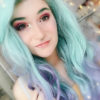 Multi coloured long curly lace front wig. A concoction of galaxies of colours make up Jupiter. With a natural twist of black roots, melting into a pastel mix of purple, mint green, blue and grey highlights. through this curly style.