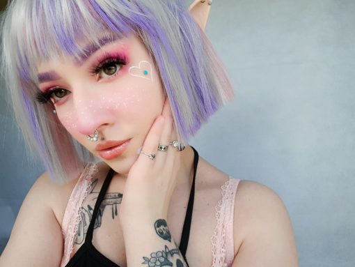 Hina - Lush Wigs UK Silver grey bob wig with bangs. Hina is a striking colour block A-line bob, with matching choppy blunt fringe. A silvery grey shade dominates, but brought to life with baby pink and purple pastel highlights running through it. A sleek and blunt style carries this distinctive look.