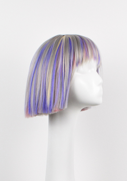 Hina - Lush Wigs UK Silver grey bob wig with bangs. Hina is a striking colour block A-line bob, with matching choppy blunt fringe. A silvery grey shade dominates, but brought to life with baby pink and purple pastel highlights running through it. A sleek and blunt style carries this distinctive look.