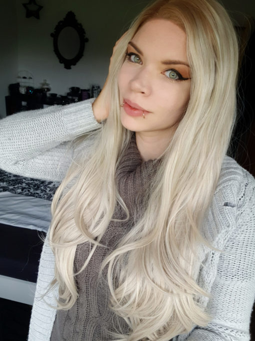 Blonde long straight lace front wig. Bunny is sleek with barely-there waves. The lace front provides a realistic hairline,  With dark blonde roots, giving a natural edge that blends into a sandy blonde shade.