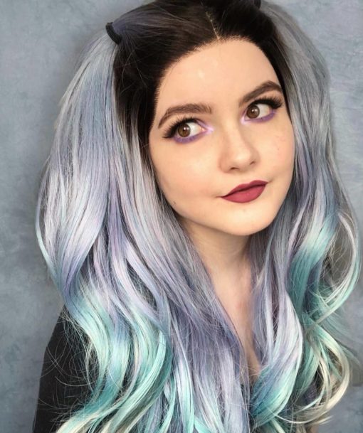 Jupiter - Lush Wigs UK Multi coloured long curly lace front wig. A concoction of galaxies of colours make up Jupiter. With a natural twist of black roots, melting into a pastel mix of purple, mint green, blue and grey highlights. through this curly style.