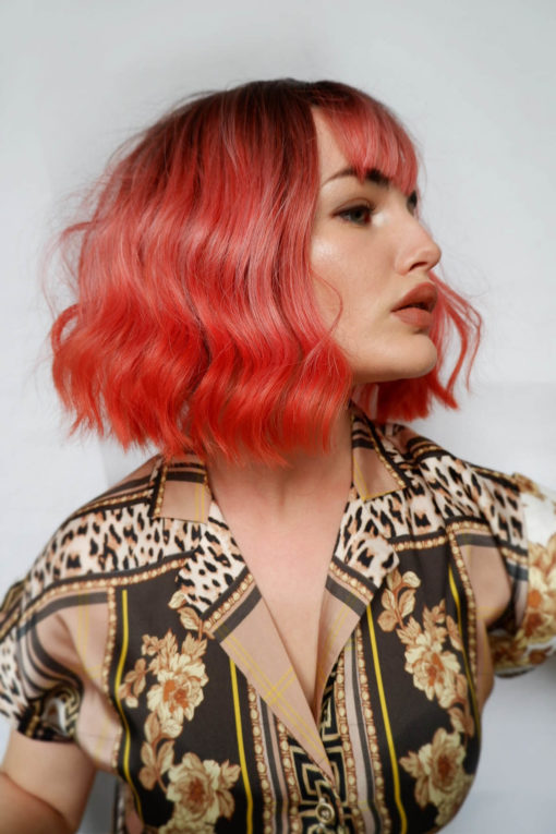 Bellini is a light choppy bob. Brown shadowed roots give a natural feel to the look, blending into a coral ombre. Skimming just above the shoulders, with a lightweight fringe to frame the face.