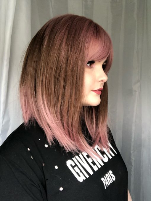 Pink and brown straight long bob with bangs. We love this unusual play on colour. Hana is a granulated sleek lob, with dusty rose pink roots, fringe and ends, with a soft caramel brown shade running through the middle.