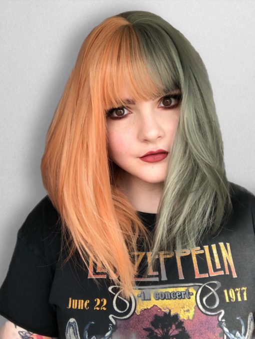 Orange and green split long bob wig. Julep takes on the dramatic colour divide. With grungy muted peach and sage green colours. Split down the centre parting and carrying the colour through the fringe. Styled straight and sleek.