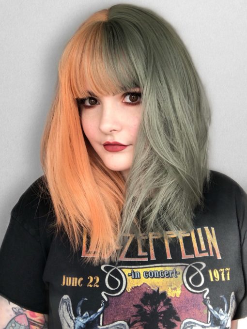 Orange and green split long bob wig. Julep takes on the dramatic colour divide. With grungy muted peach and sage green colours. Split down the centre parting and carrying the colour through the fringe. Styled straight and sleek.