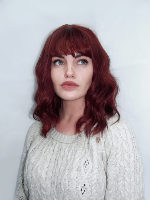 This is one of our favourite lob's. Poison Apple is a rich red maroon shade from roots to tips. Styled in loose waves for volume and a full fringe.