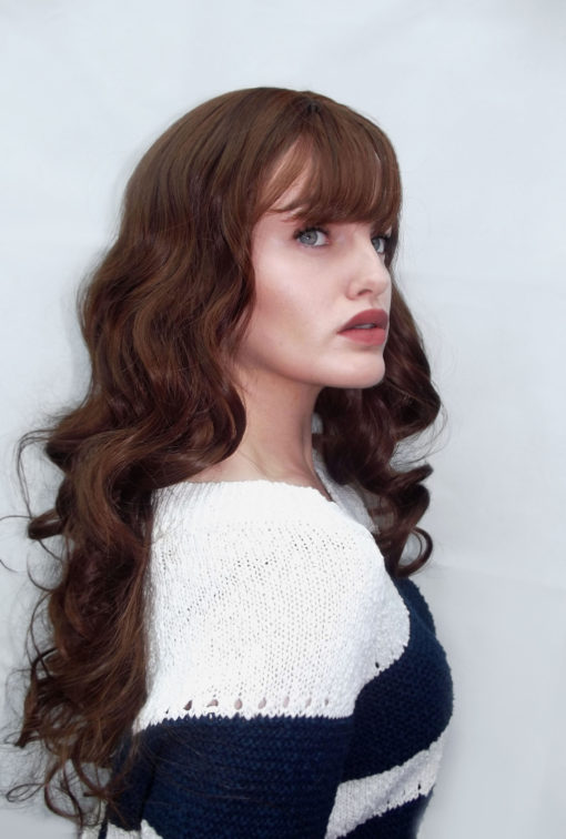 Voluminous, beautiful curls make Praline a perfect princess style. A rich golden brown colour with a long, blown out wispy fringe, this style is pure glamour and thanks to it's natural look can take any outfit up a notch. Shake it out for even more volume and extra movement.