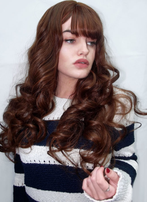 Praline - Lush Wigs UK Voluminous, beautiful curls make Praline a perfect princess style. A rich golden brown colour with a long, blown out wispy fringe, this style is pure glamour and thanks to it's natural look can take any outfit up a notch. Shake it out for even more volume and extra movement.