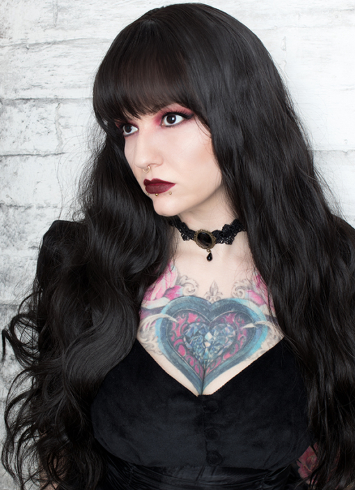 Conjure some gothic glamour with Apparition. Warm black from roots to tips. Loose waves that fall to the waist. Long invisible layers to add body and movement to the look. With a wispy fringe that frames the face.