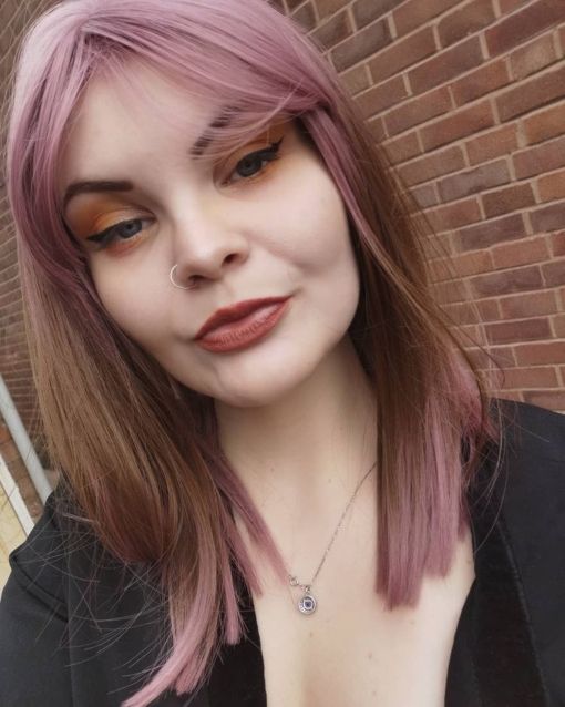Pink and brown straight long bob with bangs. We love this unusual play on colour. Hana is a granulated sleek lob, with dusty rose pink roots, fringe and ends, with a soft caramel brown shade running through the middle.