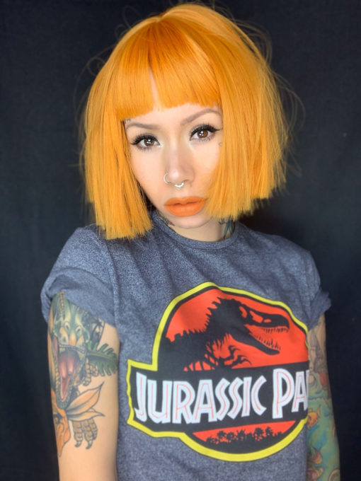 Bright orange yellow choppy bob wig. Azul gives us the brightest orange sunshine, we love it! This wig is a perfect pop of colour. Making it quirky and cute.