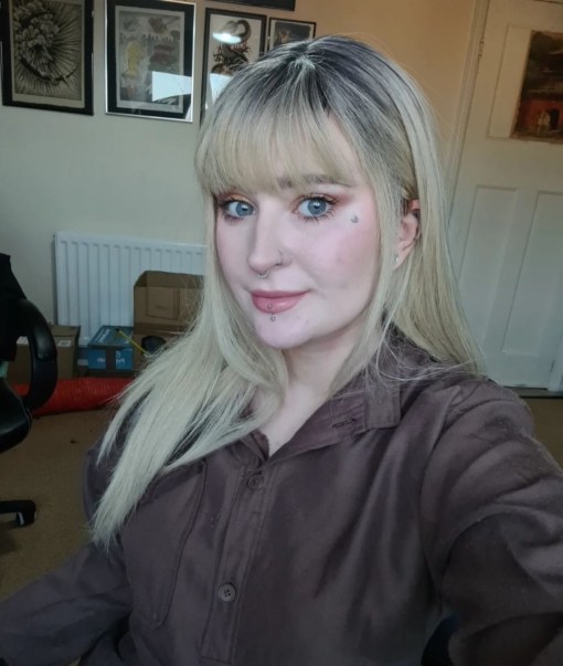 Long blonde wig with fringe. Amelia delivers a cool and natural style. Cool black grown out roots blend into a light ash blonde. Sleek and long falling just to the waist with a choppy fringe. One of our natural looking wigs thats versatile to style and easy to maintain.