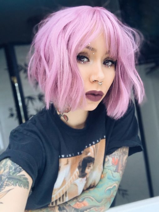 A jaw skimming deep lilac bob from roots to tips. Sleek from the centre parting with a light fringe. Its blunt cut is thick and full with a slight wave for texture. Lightweight and easy to maintain.