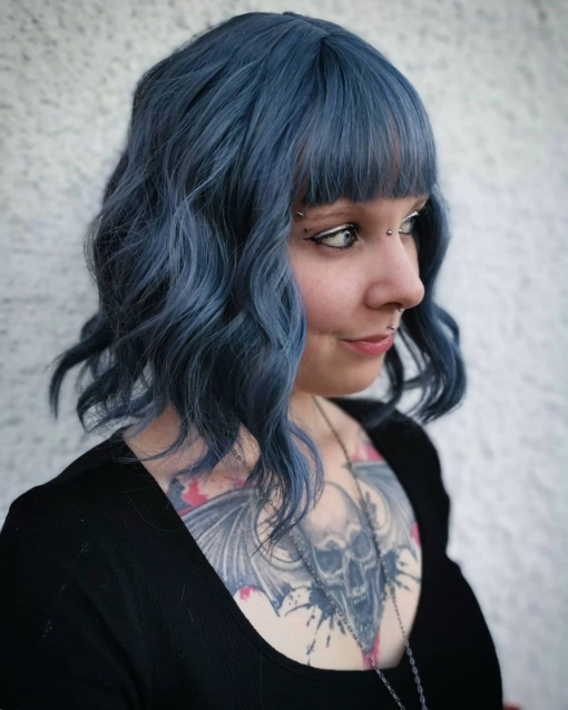 True blue is a bright and rich colour that comes in a blue indigo shade, from roots to tips. Loose beachy waves fall to the shoulders, with an airy fringe to frame the face.