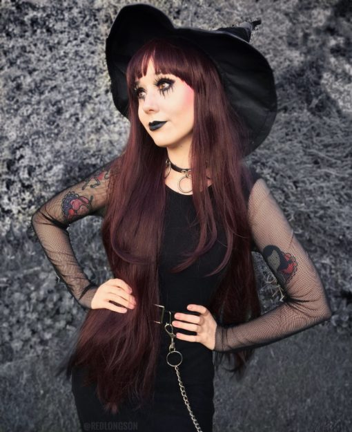 Dark very long straight wig. Be ready to call the corners in Coven. A dark brown hue with burgundy highlights, and long layers for dimension.