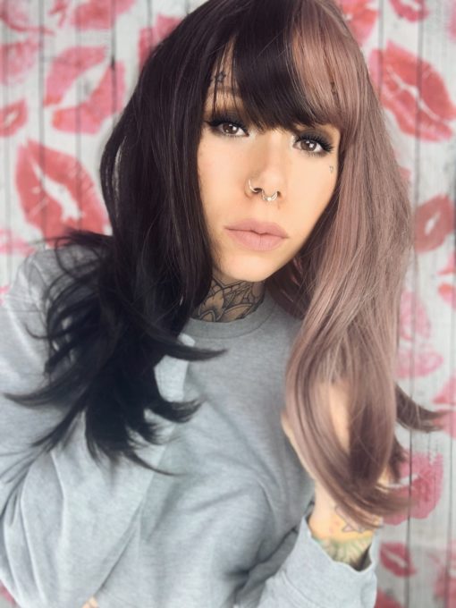 Black and mauve split long wig with bangs. Esmee takes on the dramatic colour divide. This soft and cute mauve and dark brown hues. Split down the centre parting and carrying the colour through the fringe.