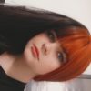 Hot topic takes on the dramatic colour divide. If you're looking for a coal black hue and a fire brick red, split either side of the centre parting. Long to the waist and thick throughout this sleek style.