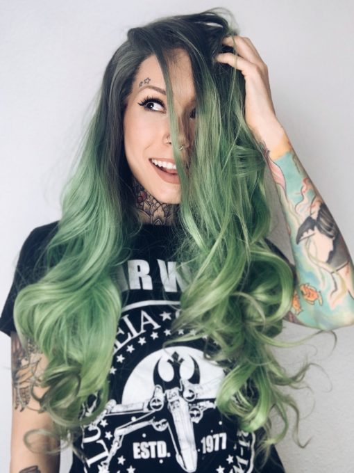 Pastel green lace front wig. Jaded is an unusual shade that just works. An emerald green muted colour with subtle dark undertones with black overgrown roots, give a natural feel to this curly mane.