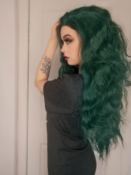 Coral - Lush Wigs UK Dark green long wavy lace front wig. A green hair lover's heaven! Coral possesses an unusual dark green colour with a metallic twist! Styled in loose crimped waves, with long layers cut in for texture.