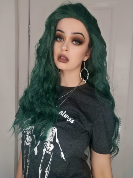 Dark green long wavy lace front wig. A green hair lover's heaven! Coral possesses an unusual dark green colour with a metallic twist! Styled in loose crimped waves, with long layers cut in for texture.