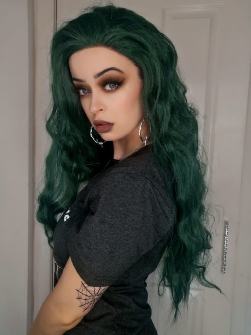 Dark green long wavy lace front wig. A green hair lover's heaven! Coral possesses an unusual dark green colour with a metallic twist! Styled in loose crimped waves, with long layers cut in for texture.
