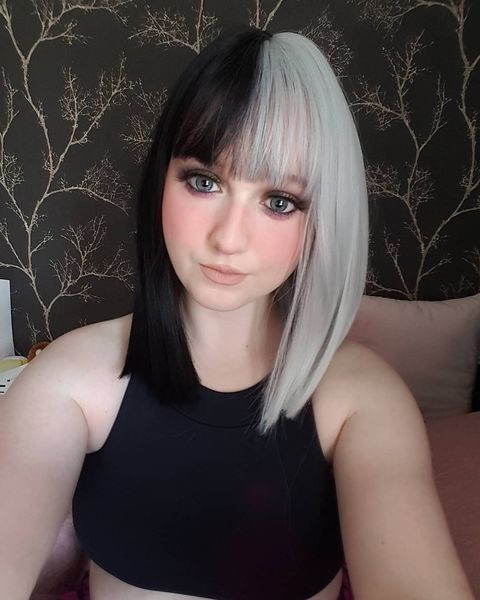 Domino takes on the dramatic colour divide. This bold statement of black and platinum hues. Split down the centre parting and carrying the colour through the fringe.