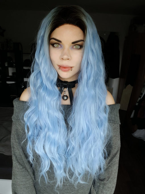 Hydra has black roots that grow into a pastel blue. The lengths are long with crimped curls, falling past the waist. Add your own look with dressing and styling. A lace front wig for a realistic hairline.