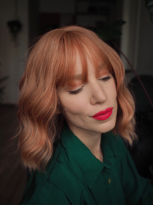 Mara is a blend of amber and sandy highlights from the roots with a peachy dip dye on the ends. A loose wave that falls just above the shoulders, Mara is easy to wear and maintain.