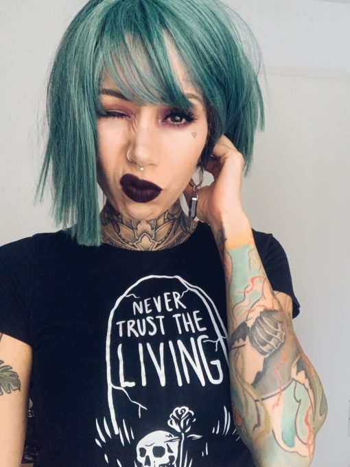 Green blue straight bob wig with bangs. Siren takes on colour dimensions, is it green or is it blue? It has various aqua and teal tones. Poker straight blunt cut that meets the jaw.