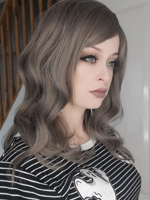 Grey mix wavy long wig. Cobble is one of our ash grey wigs, with subtle brown hues creating a natural twist on grey colour. A style with loose waves that falls just past the shoulders with a fringe that adds softness to the face.