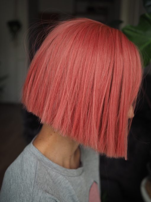 Pink straight bob wig with bangs. Make a statement in this striking style. Fresh rose hues set this poker straight blunt cut.