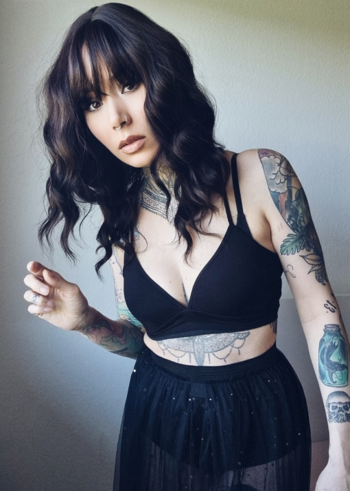 this long bob lob comes in a very dark cocoa shade from roots to tips. Styled in loose tousled waves with layers and a blunt sleek fringe.