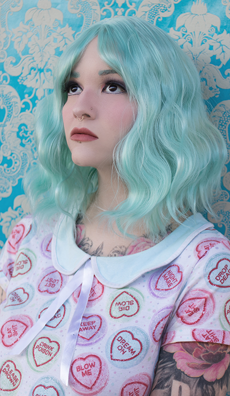 Green wavy bob wig with bangs. Mint Tea will transform your look with this exceptional style. A cute pastel green shade in loose beachy waves.