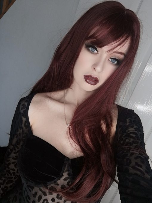 Wine red long straight wig with bangs. Throwback to the hairstyles of the 70s, is Mulberry in a deep cherry colour.