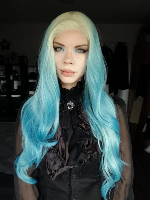 Light blue long wavy lace front wig. Essential for any mermaid look. With pearl blonde roots that blend into a mix of pale blue hues, that reflect tones of coral reefs. Long waist length style with long layers and big barrel brush curls, to add texture and movement. The lengths make it versatile to play with different styles.