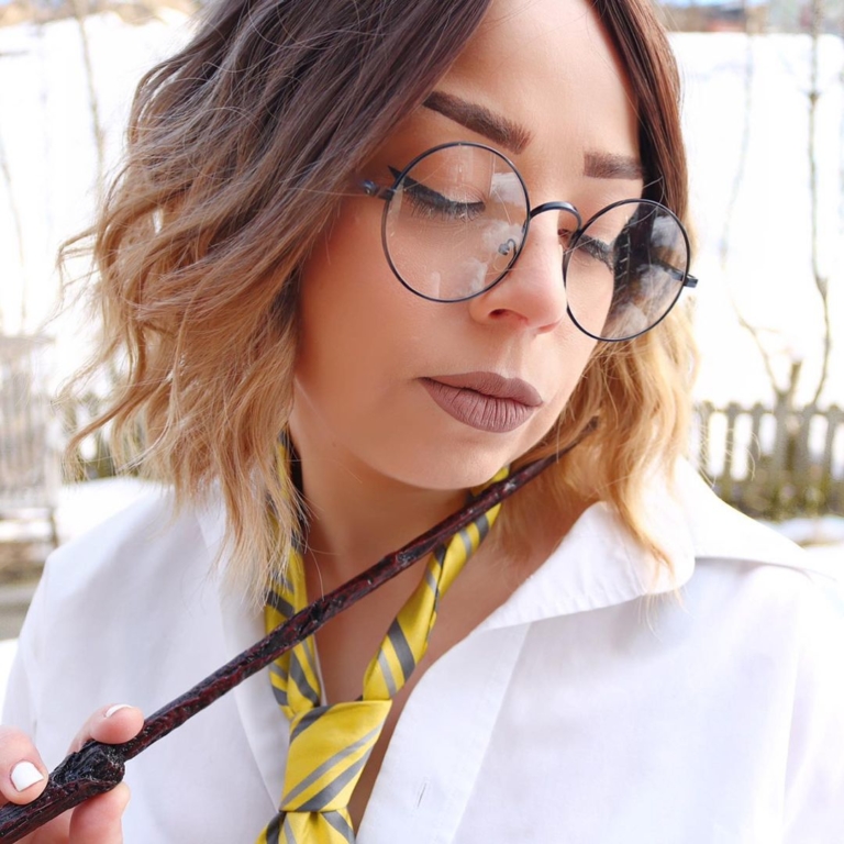 A fringeless A-line bob styled in a loose wave. Warm brown tones from the roots, blend into a dark blonde tint on ends of the hair. A fresh natural look that is casual and easy to maintain.