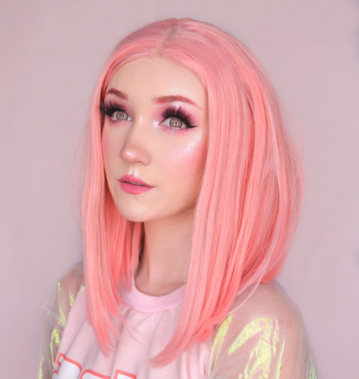 Pink straight bob lace front wig. A super cute pastel rose pink colour from roots to tips. This sleek graduated long bob cut that falls just to the shoulders. Parted in the centre. The perfect bright chic look.