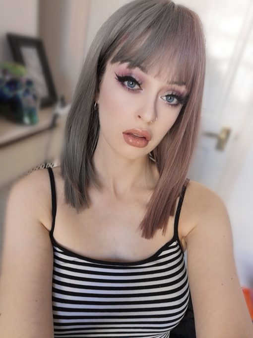 Half pink half grey split straight bob wig. Perish takes on the split colour technique. A grey and rose pink. Split straight down the middle so the different colours fall either side of the centre parting. Styled straight and sleek.