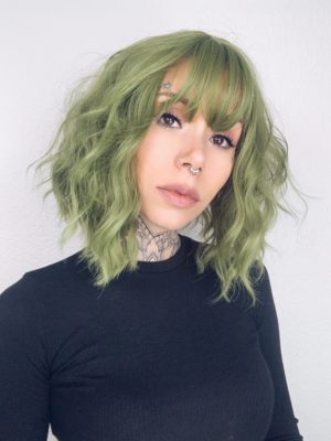 A bob with a beautiful jade green colour from roots to tips with a blunt sleek fringe. Styled in loose waves that fall just too the shoulders. 