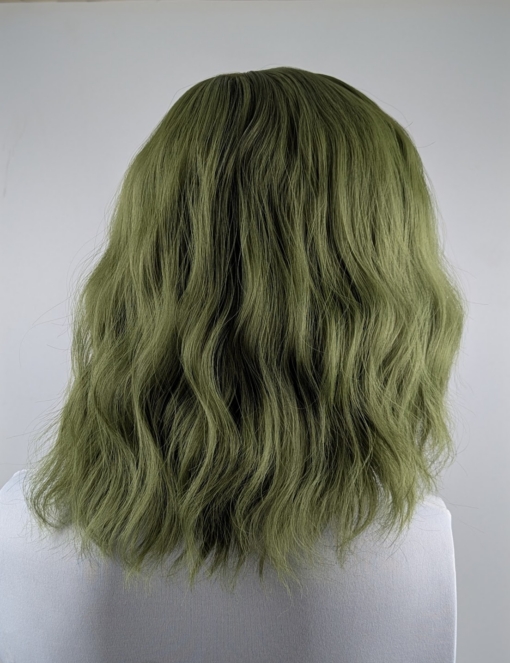A bob with a beautiful jade green colour from roots to tips with a blunt sleek fringe. Styled in loose waves that fall just too the shoulders.