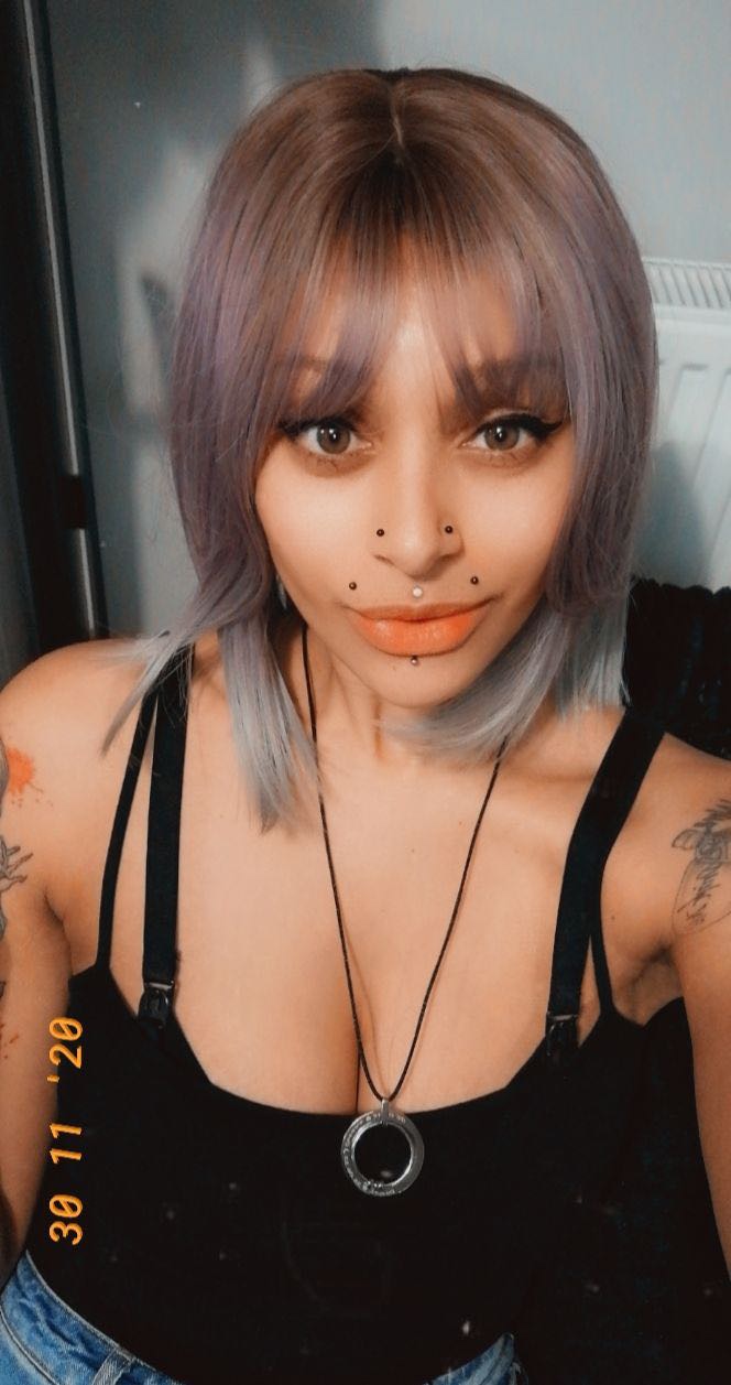 A beautiful tricolour style ombre. From light brown roots to lilac and grey mix, finished with a dip dye pearly grey colour. It's cut into a long sleek bob with layers making this style easy to maintain. A light blunt fringe finishes the look.