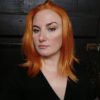 Vibrant orange long bob lace front wig. When the sun goes down, get the look for the night! In this sleek one length poker straight style of bright spiced orange tones. 