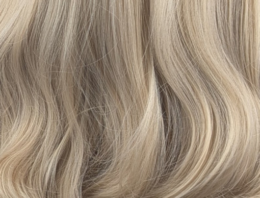 Eliza - Lush Wigs UK This long and sleek wig with a gentle blow out wave. Has a natural feel of light brown shadowed roots, that blend into a sun-kissed blonde. Big loose waves are long, and falling just to the waist with a full sleek blunt fringe.