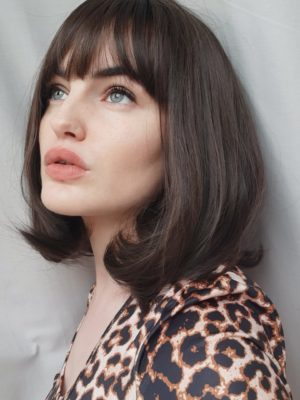 Lilly is a soft and natural warm chestnut tone from roots to tips. A graduated cut that curls under, falling just below the jawline, with a sleek blunt fringe. A simple yet stylish cut that’s easy to maintain.