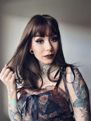 A sleek straight style in a natural chestnut colour. With long layers cut in and a blow out style to add fullness and movement. With a sleek blunt fringe.